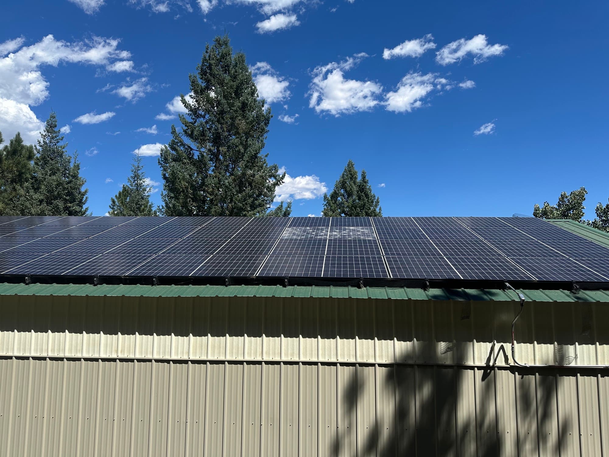 Rooftop solar array under a clear Colorado sky in the Denver foothills